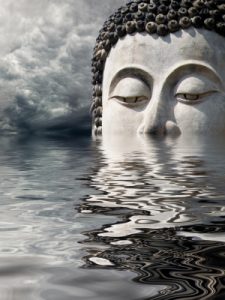 Buddha head reflected in water